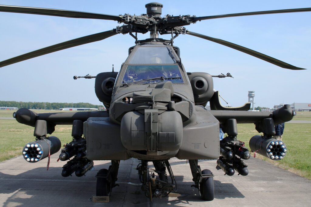 A military helicopter on a runway.
