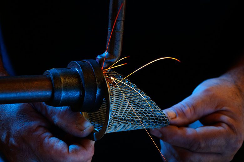 a person welding a filter
